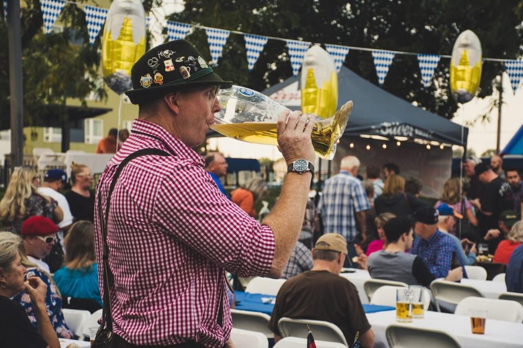 Man at Oktoberfest enjoying a large beer.